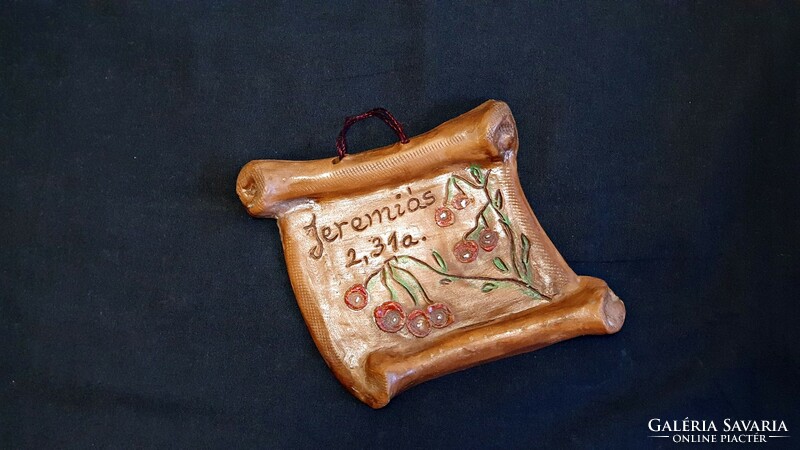 Small handmade ceramic wall decoration. It is religious in nature.