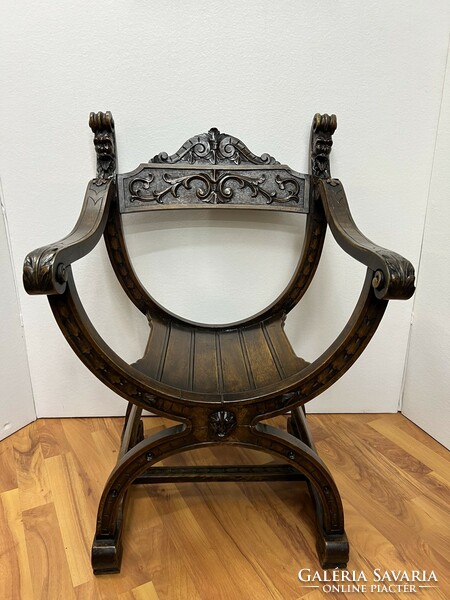 Antique carved Savonarola armchair