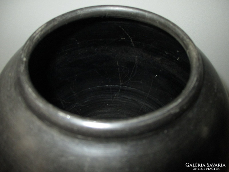 Black vase with a ram pattern