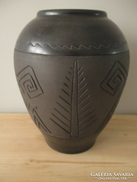 Black vase with a ram pattern