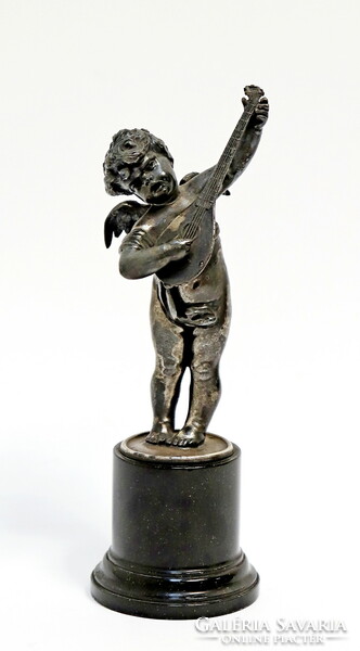 A putto playing a lute, a pewter statue