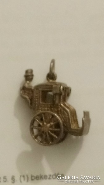 An antique silver carriage with a carriage shaped pendant, with traces of former gilding