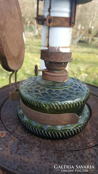 Old kerosene lamp with a rare green glass container