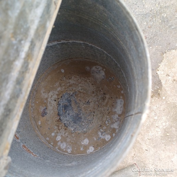 Old tin watering can with lid