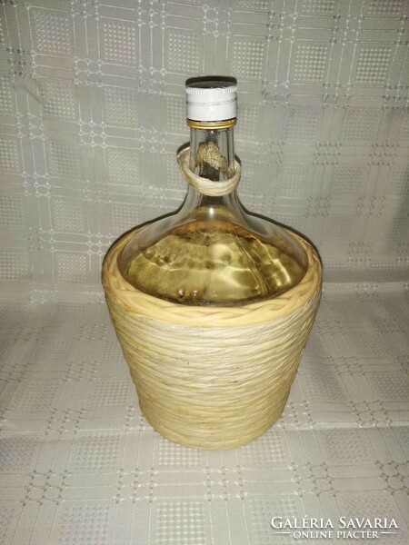 Glass bottle in wicker holder (a7)