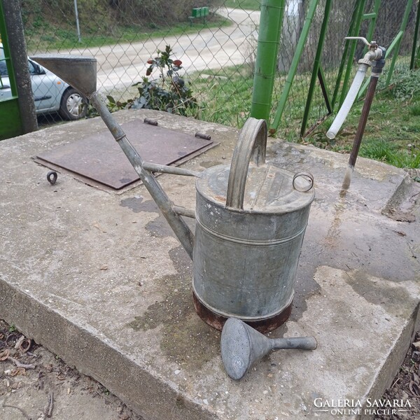 Old tin watering can with lid