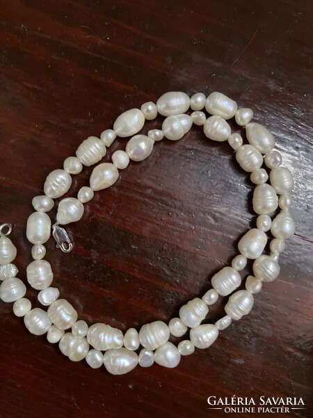 String of real pearls from larger beads, with a silver clasp.