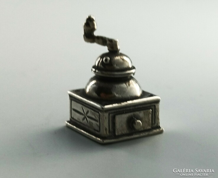 Silver ornament, grinder