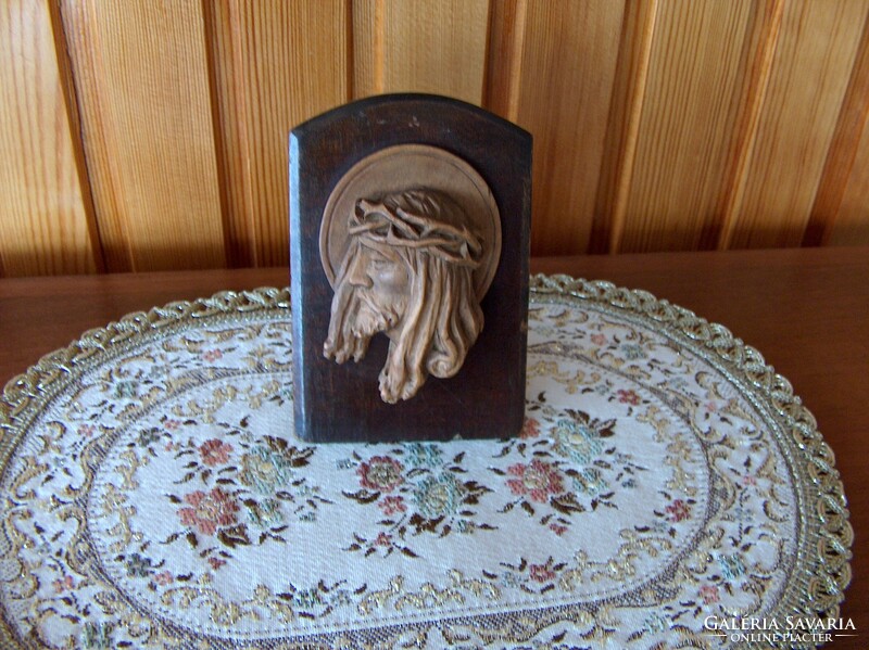 Beautiful old christ head with wooden carving standing on table