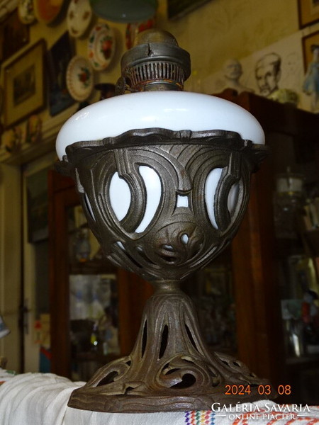 Antique table kerosene lamp in an Art Nouveau openwork iron basket