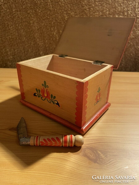 A small folk art chest with a knife