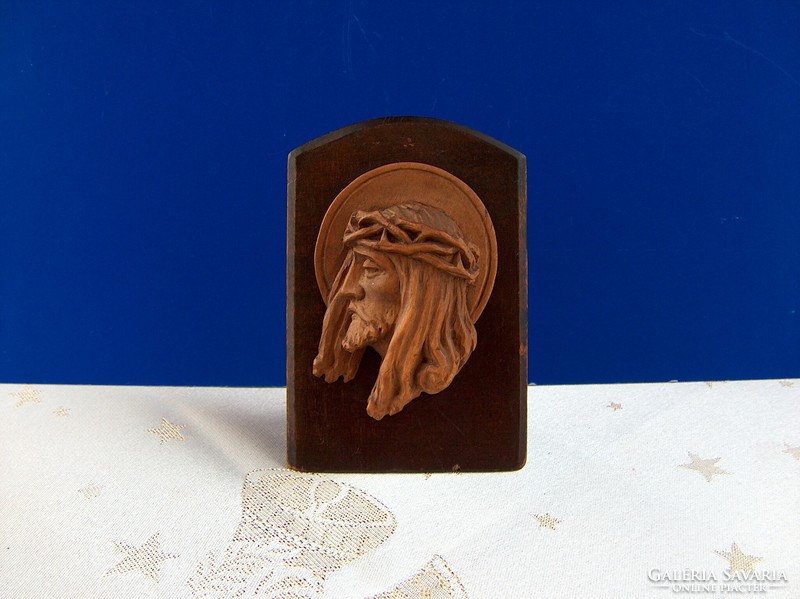 Beautiful old christ head with wooden carving standing on table