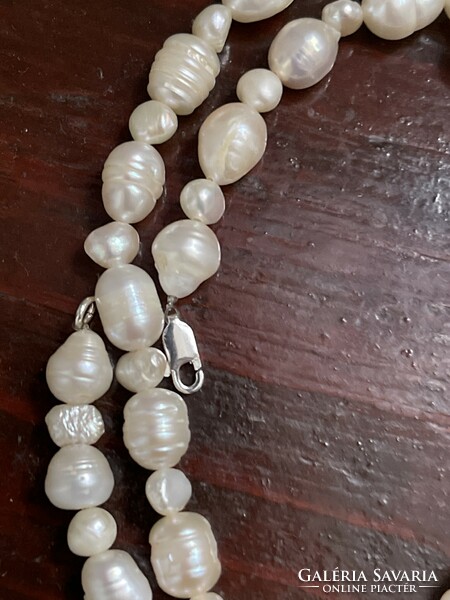 String of real pearls from larger beads, with a silver clasp.