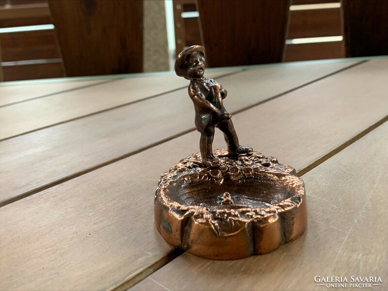 Old copper ring holder with a statue of a peeing boy