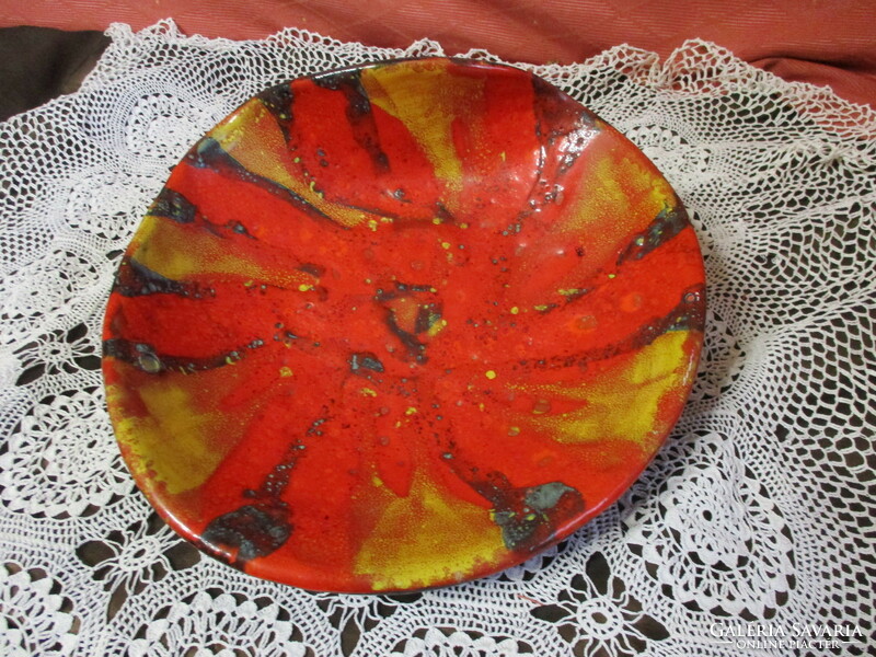 A large ceramic wall plate with a special shape