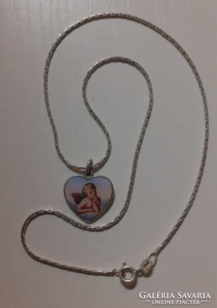 Old fire enamel heart-shaped angel locket on a silver chain marked with a silver cret