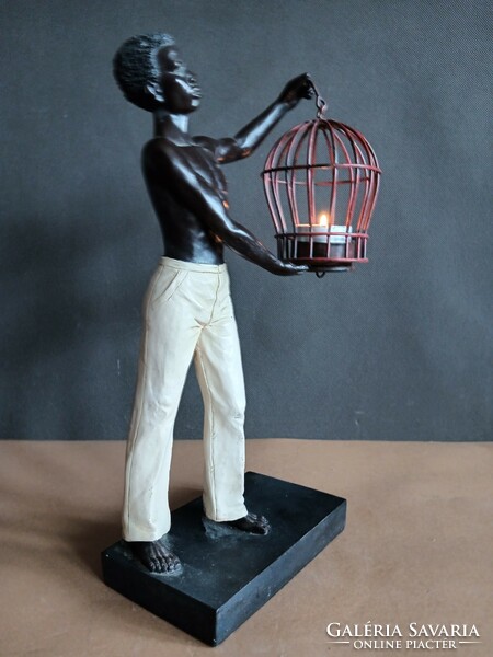 Art-deco figure statue of a black boy with a lamp. Negotiable.