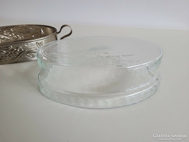 An old glass bowl in a metal holder