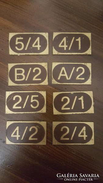 Old copper tickets room door numbers