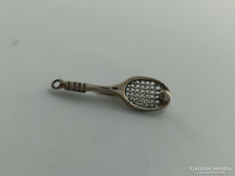 Silver pin, tennis racket with ball