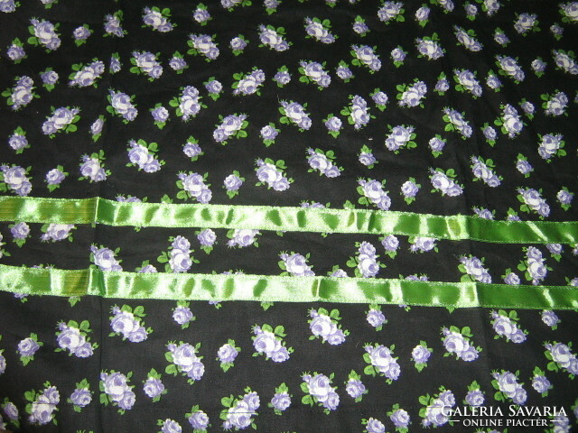 A beautiful small white-purple rosy-green ribbon decorated with a large size apron