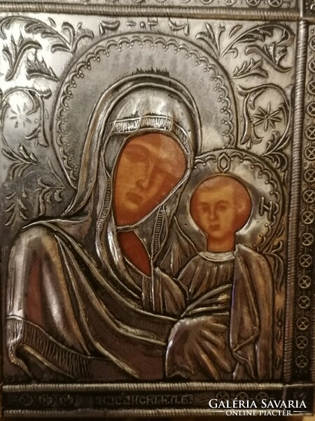 Silver metal icon on a wooden background