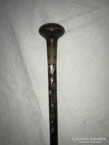 A walking stick with a beautiful ball end, shell pearl case, silver inlay