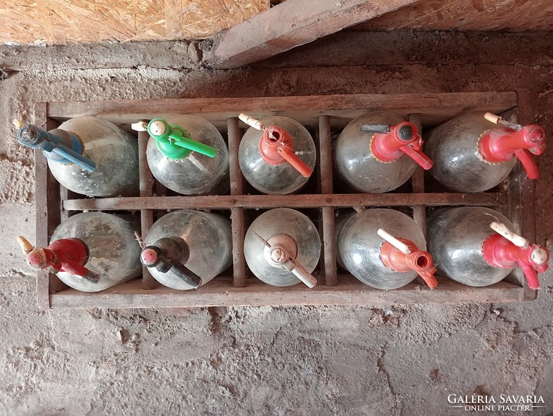 10 pcs old soda bottles in a wooden crate.