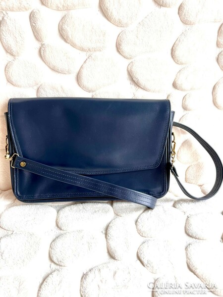 Elegant retro women's bag with golden hardware on the sides and bottom of dark blue leather