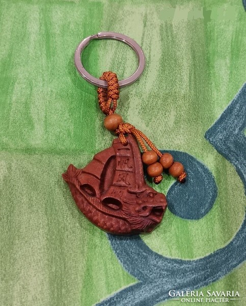 Real room. Feng shui rosewood key ring with dragon sailing