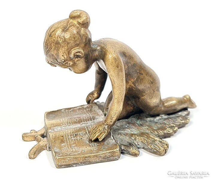 Charming antique copper/bronze statue - little girl reading sheet music on an oak leaf
