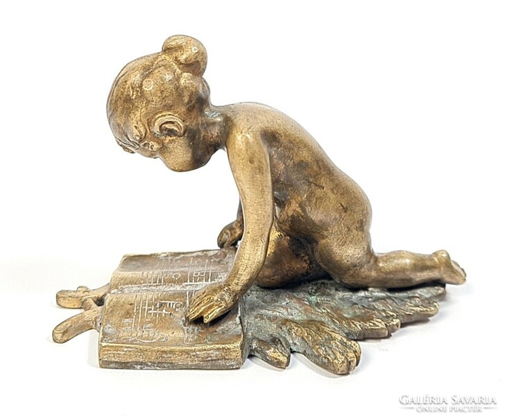 Charming antique copper/bronze statue - little girl reading sheet music on an oak leaf