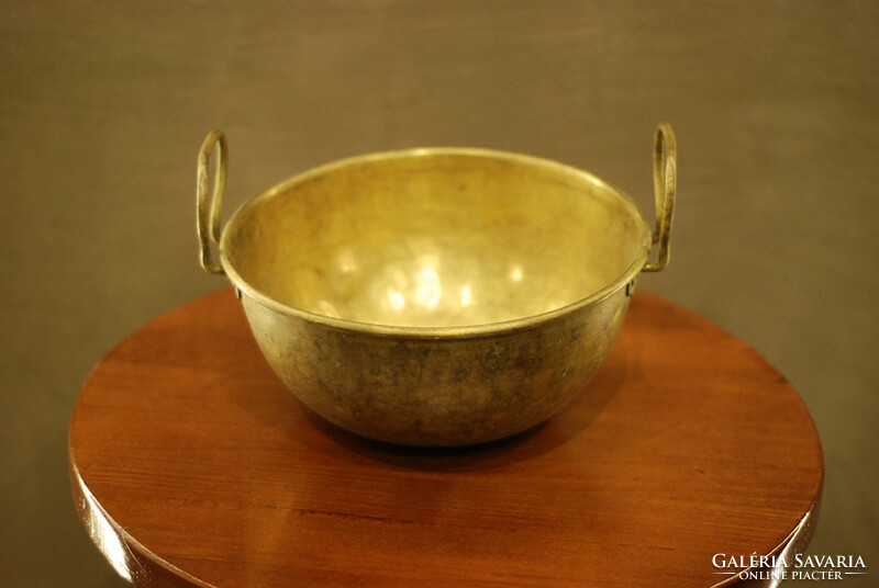 Yellow copper cauldron in patina condition