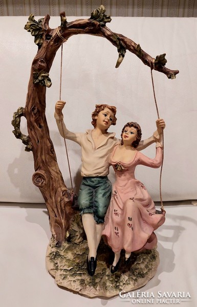 Lovers on a swing, a romantic statue even for a wedding