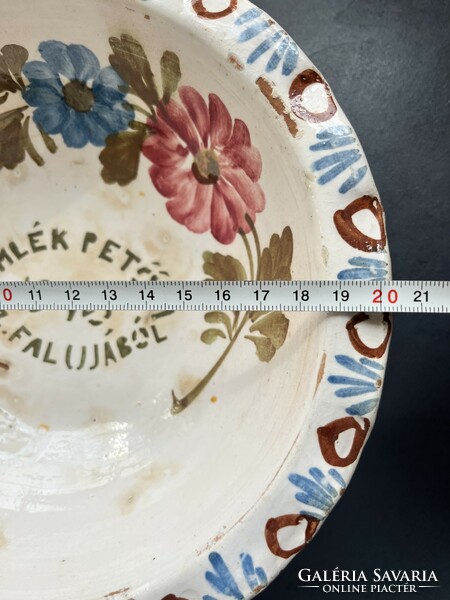 Old, unmarked, painted folk earthenware wall plate with the inscription 
