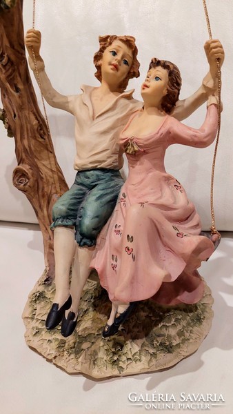 Lovers on a swing, a romantic statue even for a wedding