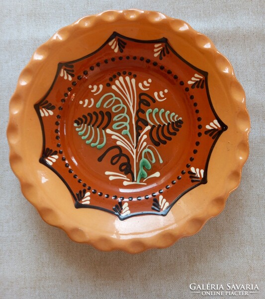 Váczi Karcagi ceramic dish in display case on the wall