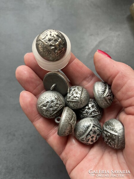 Old metal buttons with a pattern of mountain grass