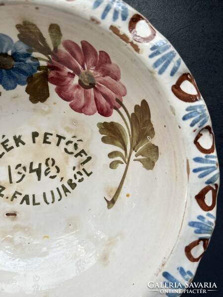 Old, unmarked, painted folk earthenware wall plate with the inscription 