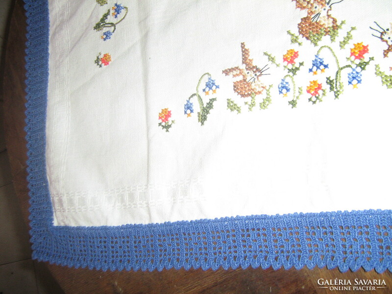Beautiful embroidered cross-stitch Easter bunny tablecloth with a crocheted edge