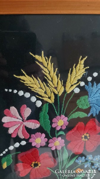 Hand-embroidered floral picture in a glazed frame