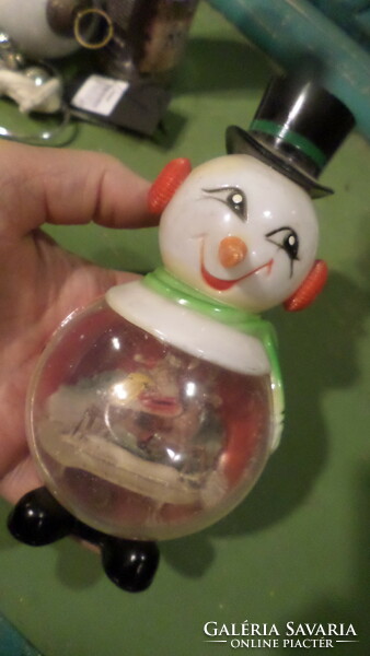 14 cm, very retro, plastic snowman. There might have been a snowball in his stomach, but there is no liquid in it anymore.