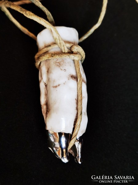 A porcelain brandy glass that can be hung around the neck in the shape of a pig's foot