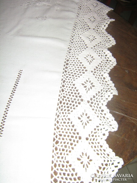 Beautiful hand-crocheted embroidered white tablecloth with a lace edge