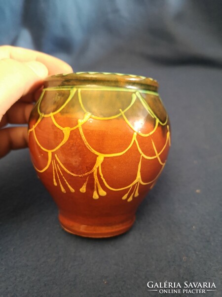 Glazed ceramic vessel decorated with old folk motifs