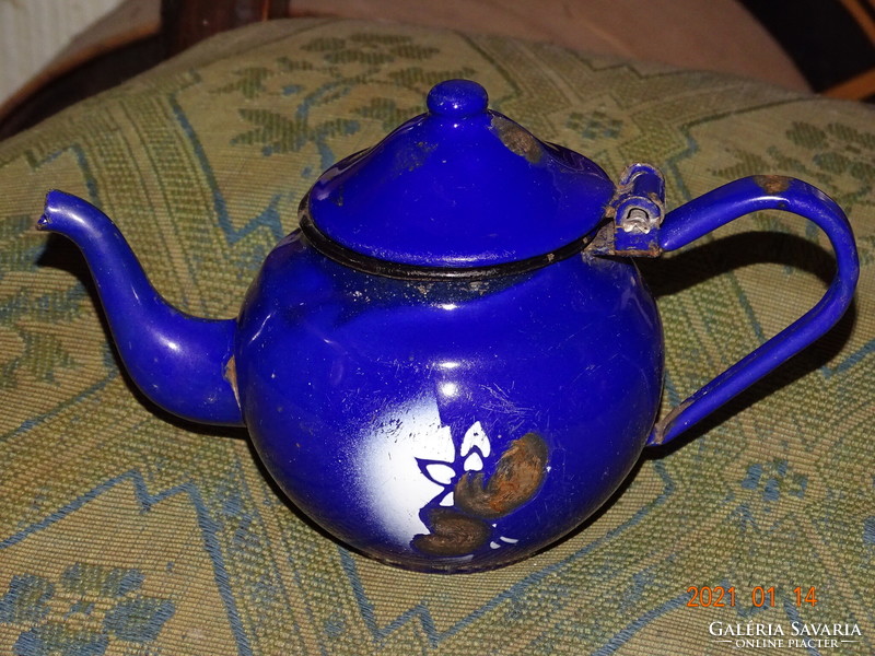 Peasant decor with blue enamel enameled jug pouring