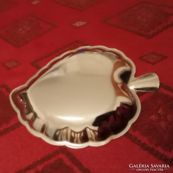 A small bowl in the shape of a silver-plated leaf