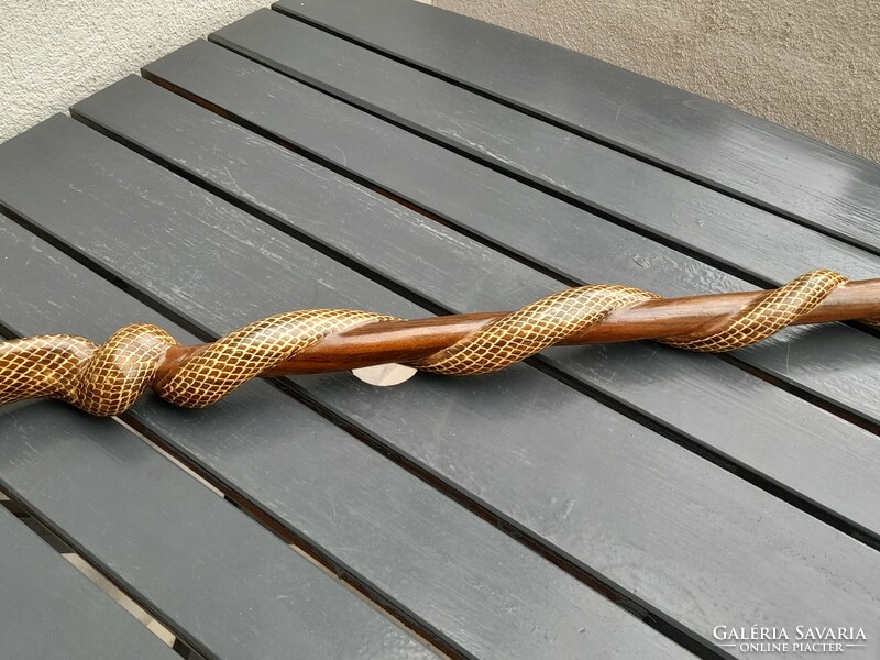 A wooden walking stick with a cobra head