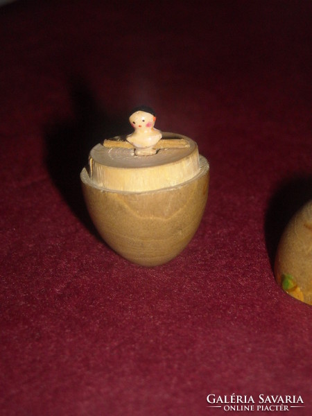 Handmade miniature doll in a wooden egg