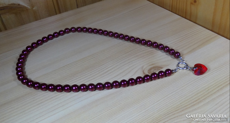 Necklaces made of cherry burgundy beautiful shiny glass beads with swarovski crystal pendants are now fashionable.